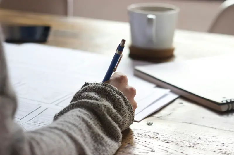 Student taking notes while studying