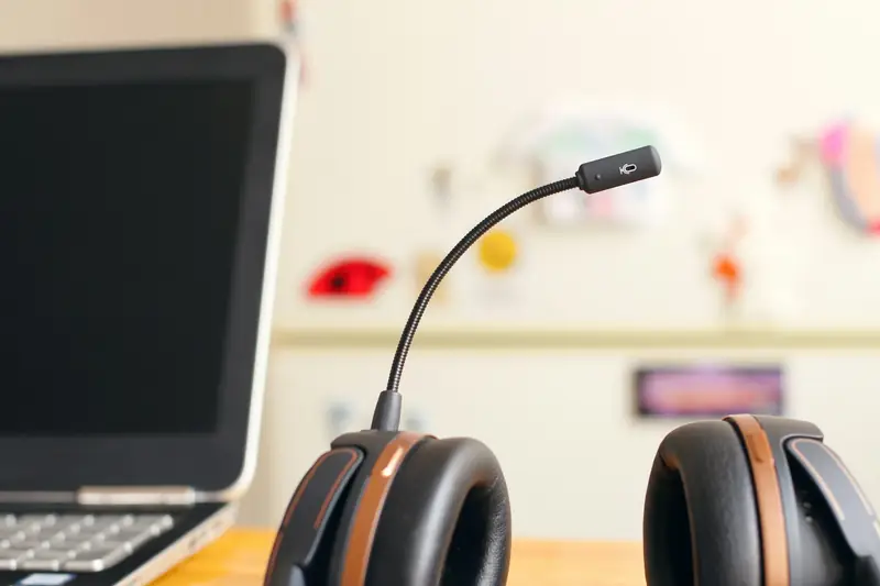 Support headset beside a laptop on a desk